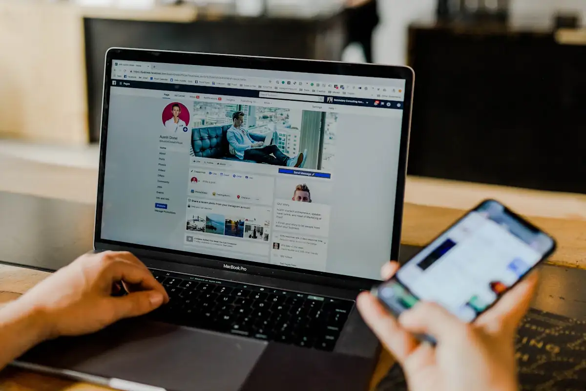 Social media marketing content being managed on laptop and phone