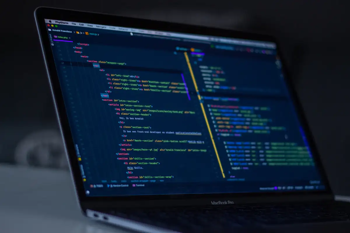 Developer writing React code for a custom website on a laptop